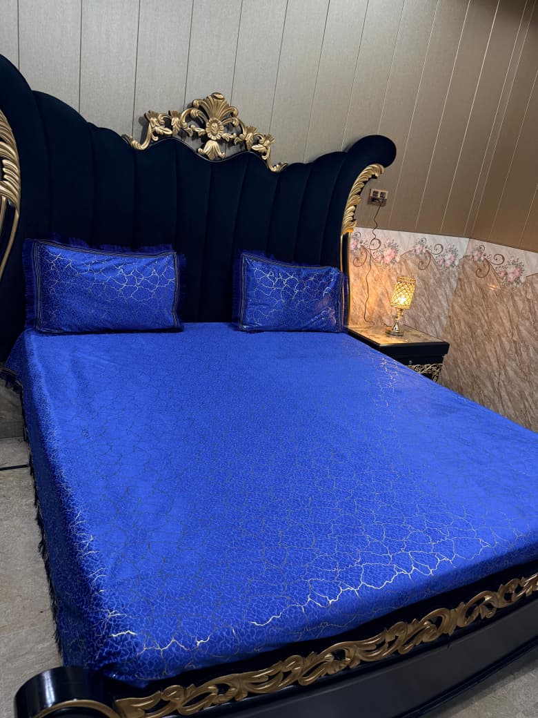 Velvet bedsheet with textured design in soft shades, from Al Ghani O Nisar, showcasing luxurious fabric and intricate pattern.