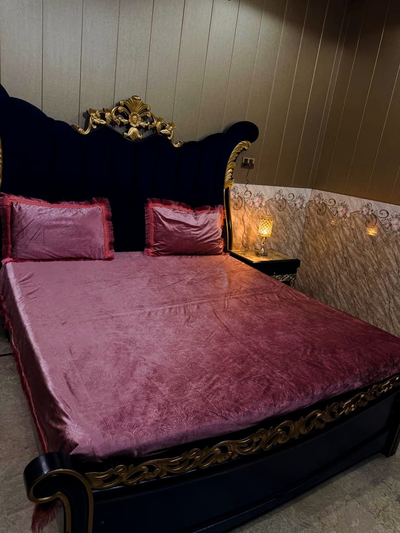 Al Ghani O Nisar embossed velvet bedsheet in rich fabric with intricate patterns, displayed on a neatly made bed.