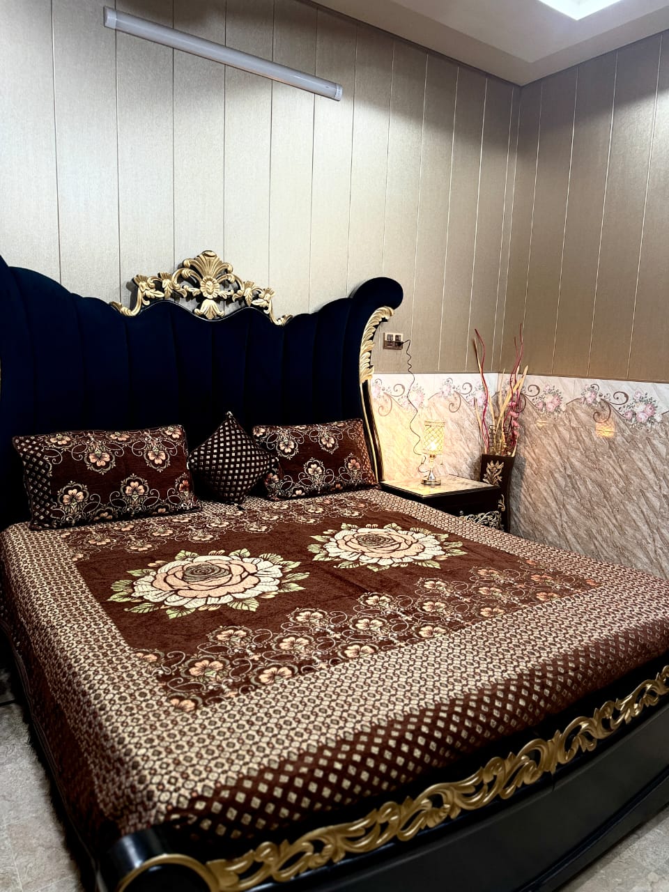 Al Ghani O Nisar Jovial Jacquard bedsheet with intricate woven patterns in vibrant colors, shown draped on a bed.