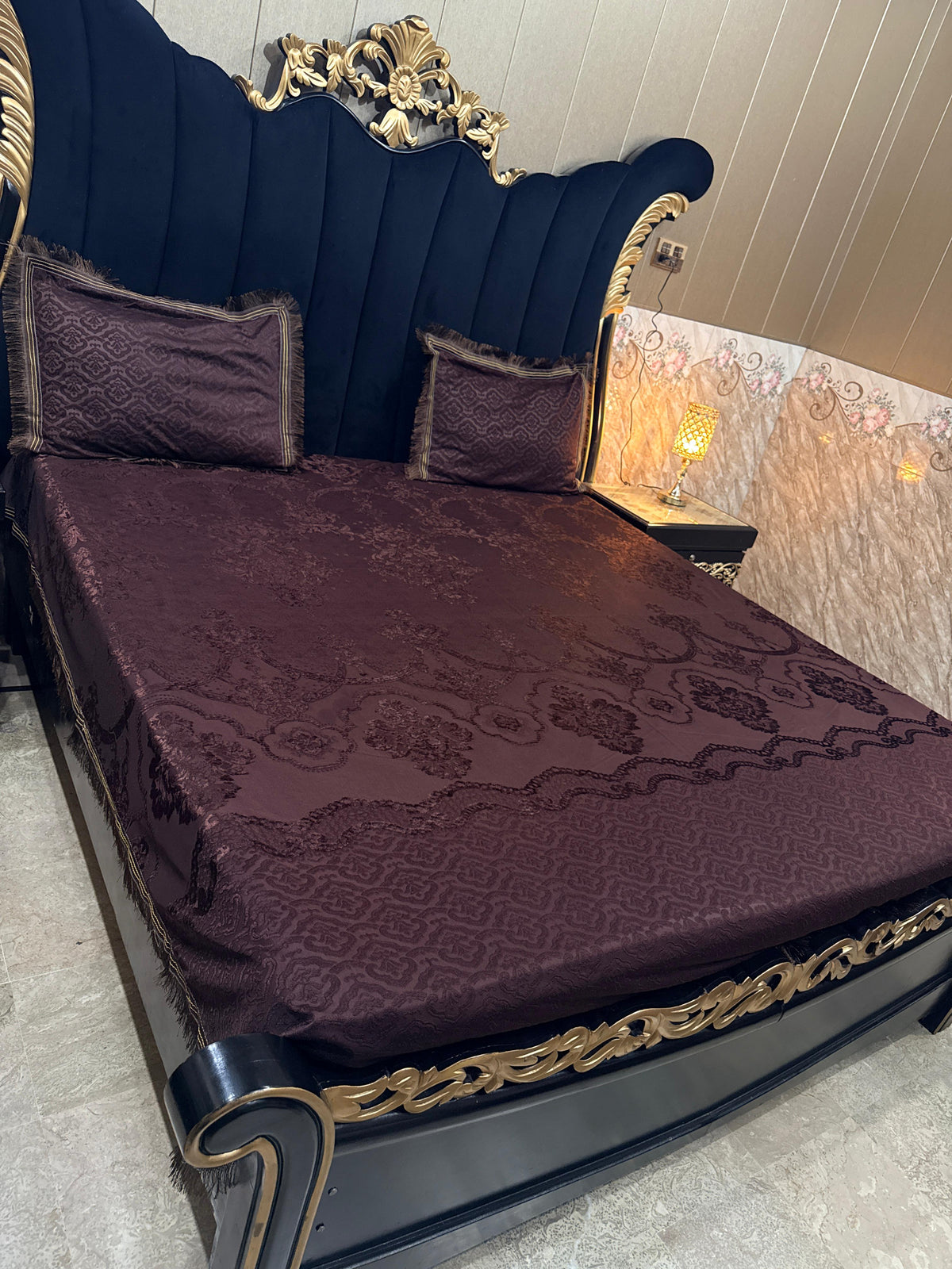 Al Ghani O Nisar Palachi bedsheet featuring intricate traditional patterns in vibrant colors, displayed on a neatly made bed.