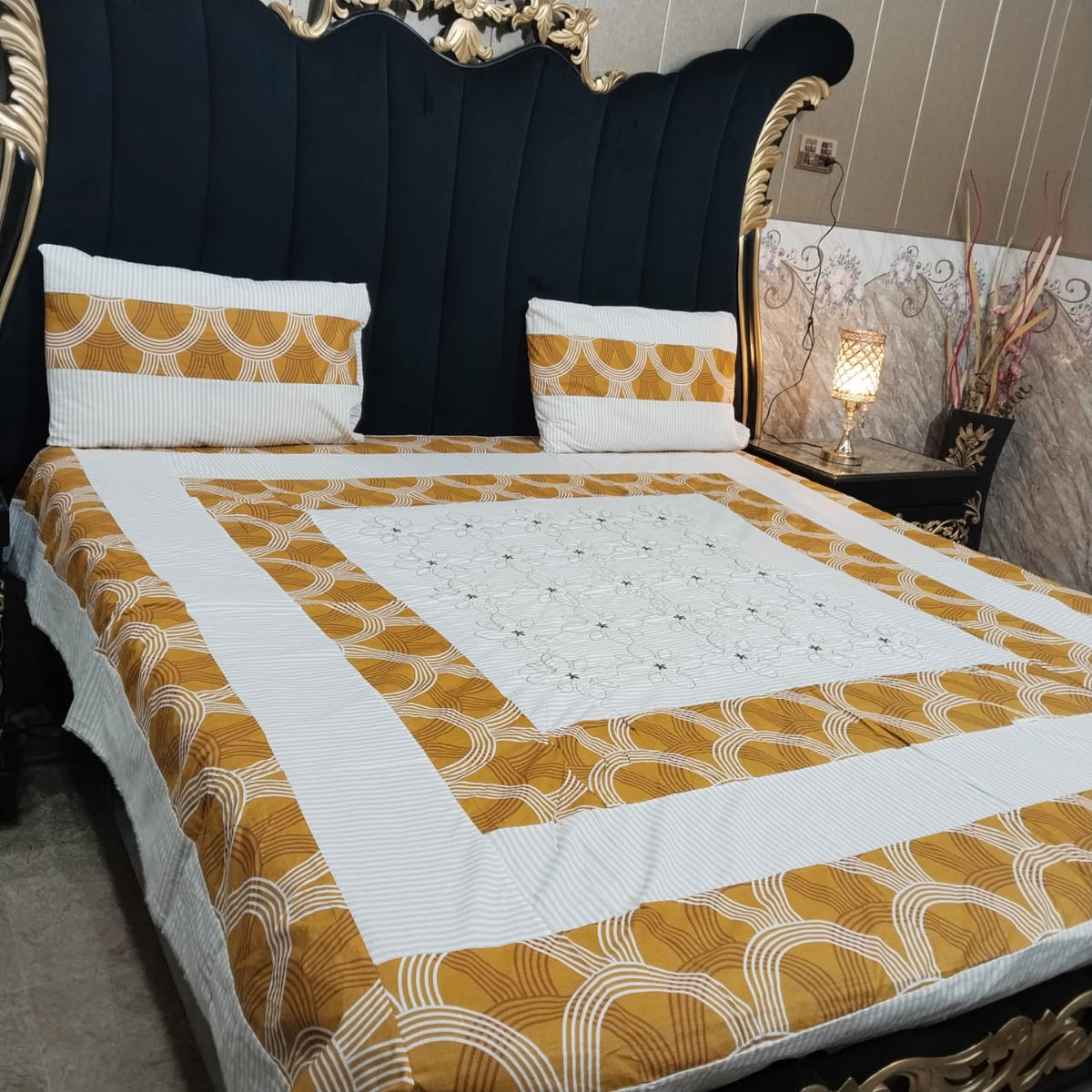 Colorful embroidered patchwork bedsheet by Al Ghani O Nisar featuring intricate designs and vibrant patterns for a cozy bedroom look.