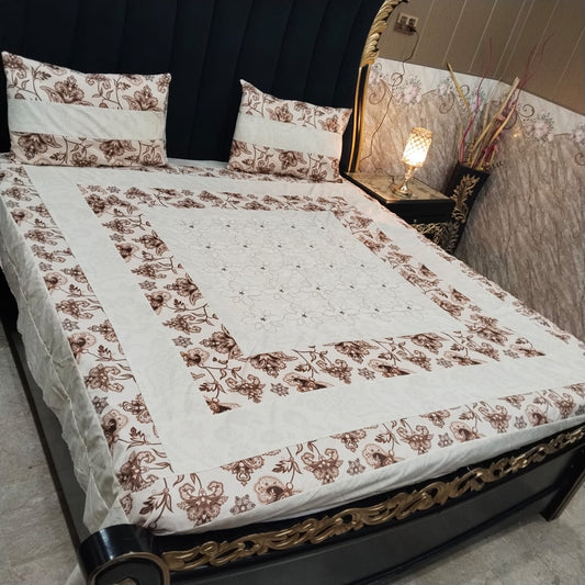 Embroidered patchwork bedsheet by Al Ghani O Nisar featuring intricate designs and vibrant colors on soft fabric.