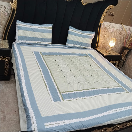 Colorful embroidered patchwork bedsheet by Al Ghani O Nisar, showcasing intricate stitching and vibrant fabric patterns.