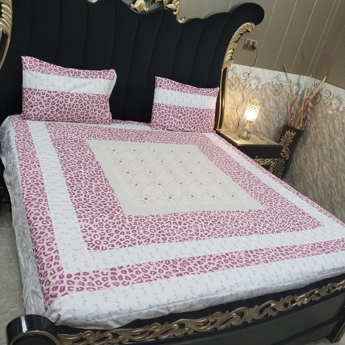 Colorful embroidered patchwork bedsheet by Al Ghani O Nisar featuring intricate, vibrant fabric patterns and detailed stitching.