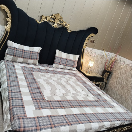 Embroidered patchwork bedsheet by Al Ghani O Nisar featuring colorful, intricate designs on soft fabric.