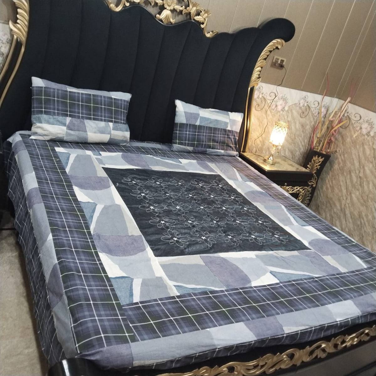 Colorful embroidered patchwork bedsheet by Al Ghani O Nisar, showcasing intricate stitching and vibrant fabric patterns.