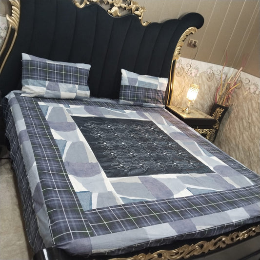 Colorful embroidered patchwork bedsheet by Al Ghani O Nisar, showcasing intricate stitching and vibrant fabric patterns.