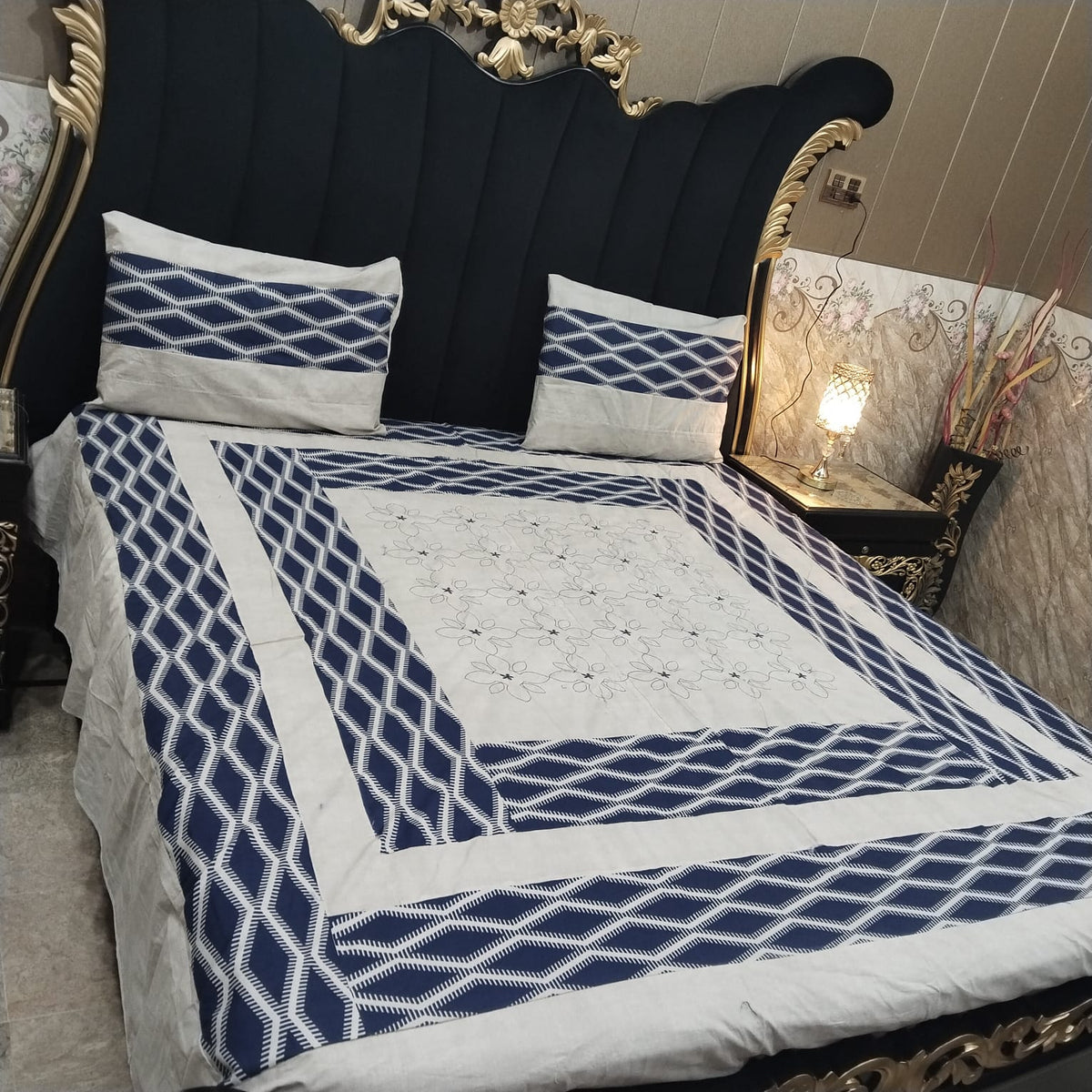Embroidered patchwork bedsheet by Al Ghani O Nisar featuring colorful, intricate patterns on soft fabric for a cozy bedroom look.