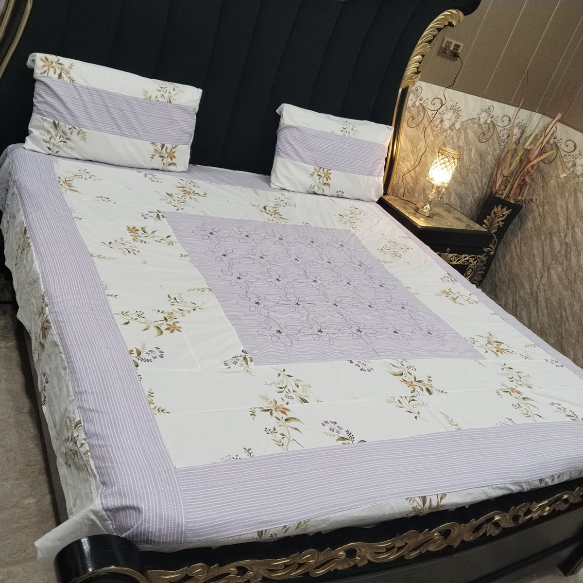 Colorful embroidered patchwork bedsheet by Al Ghani O Nisar with intricate stitching and vibrant fabric patterns.