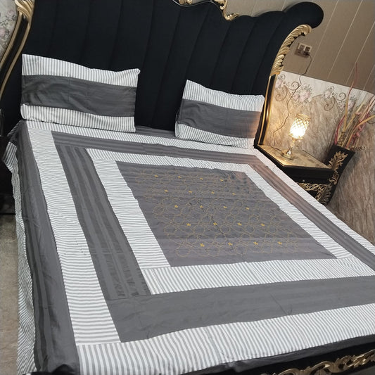 Embroidered patchwork bedsheet by Al Ghani O Nisar featuring colorful, intricate stitched patterns on soft fabric.