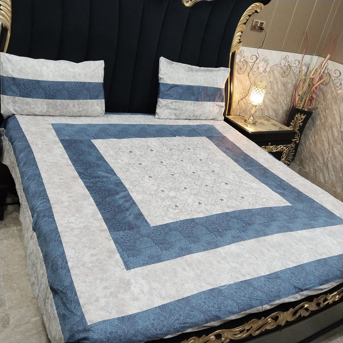 Colorful embroidered patchwork bedsheet by Al Ghani O Nisar, showcasing intricate stitching and vibrant fabric patterns.