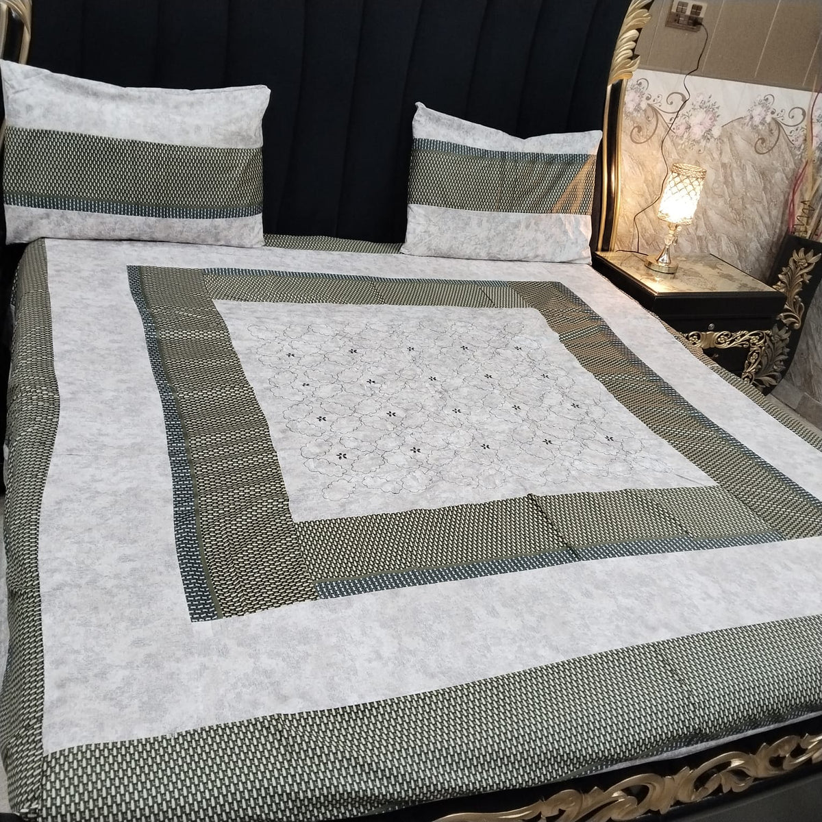 Colorful embroidered patchwork bedsheet by Al Ghani O Nisar with intricate designs and vibrant patterns.