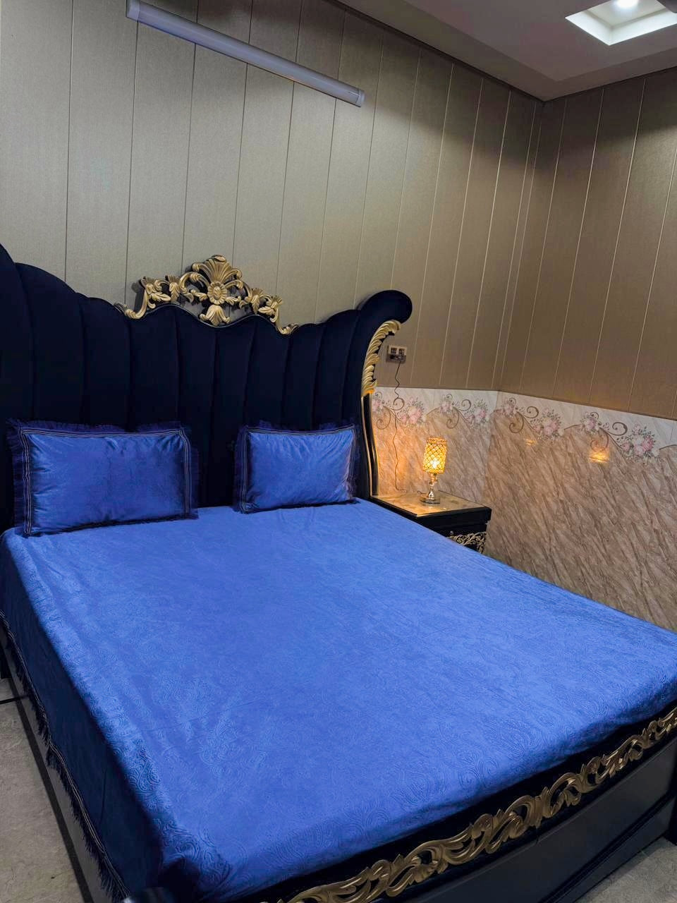 Embossed velvet bedsheet by Al Ghani O Nisar featuring intricate patterns in rich fabric, displayed on a bed.